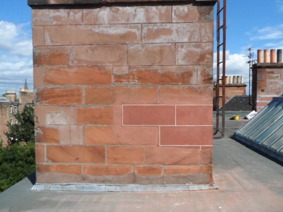a brick wall with a metal scaffolding