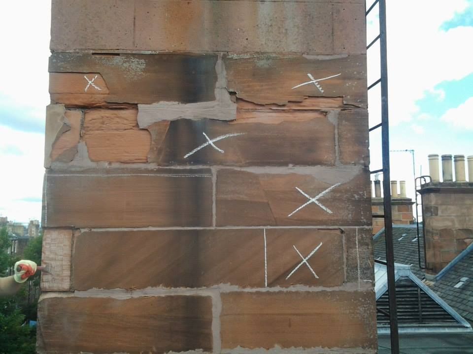a brick wall with white chalk drawn on it