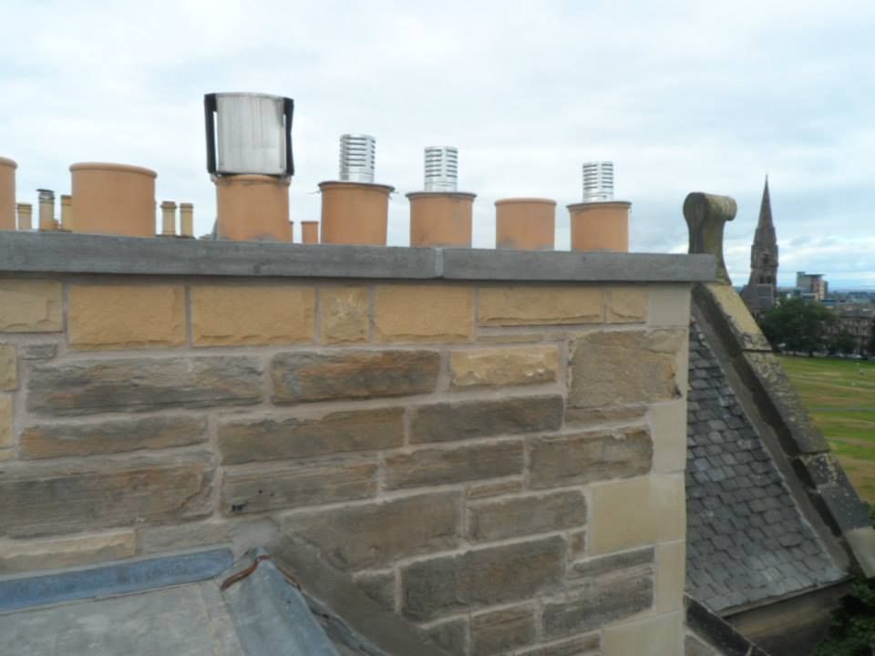 a roof with several chimneys on top