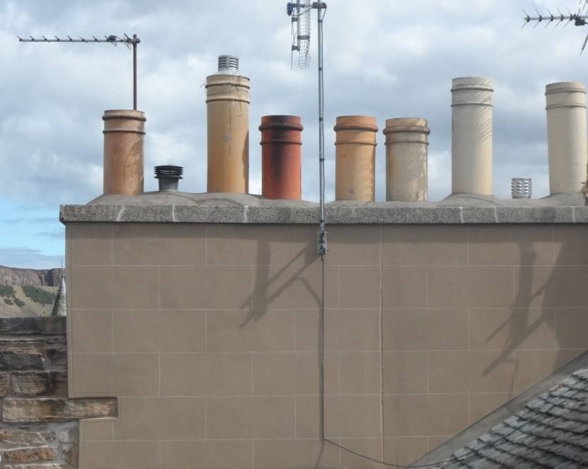 a group of chimneys on top of a building